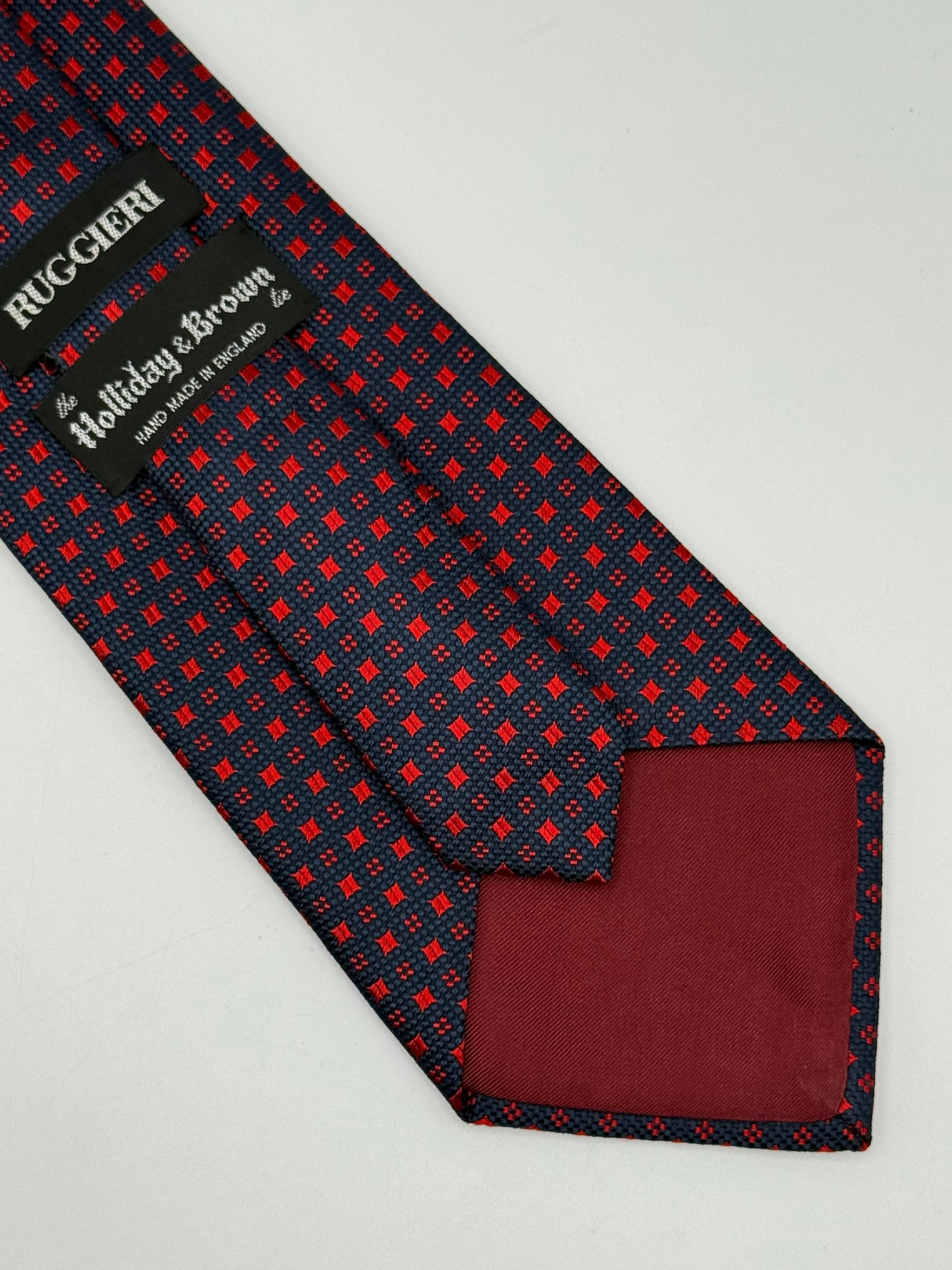 Dark blue jacquard silk tie whit small geometric pattern