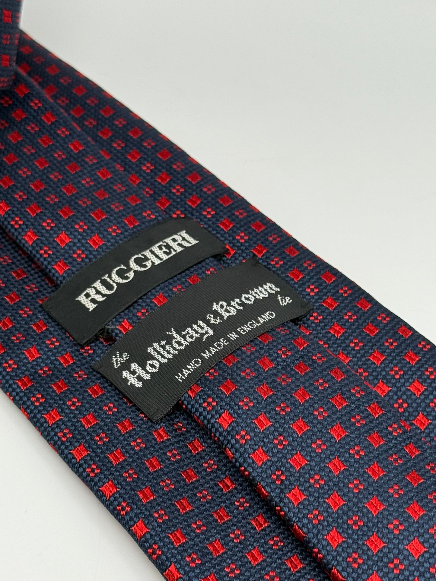 Dark blue jacquard silk tie whit small geometric pattern