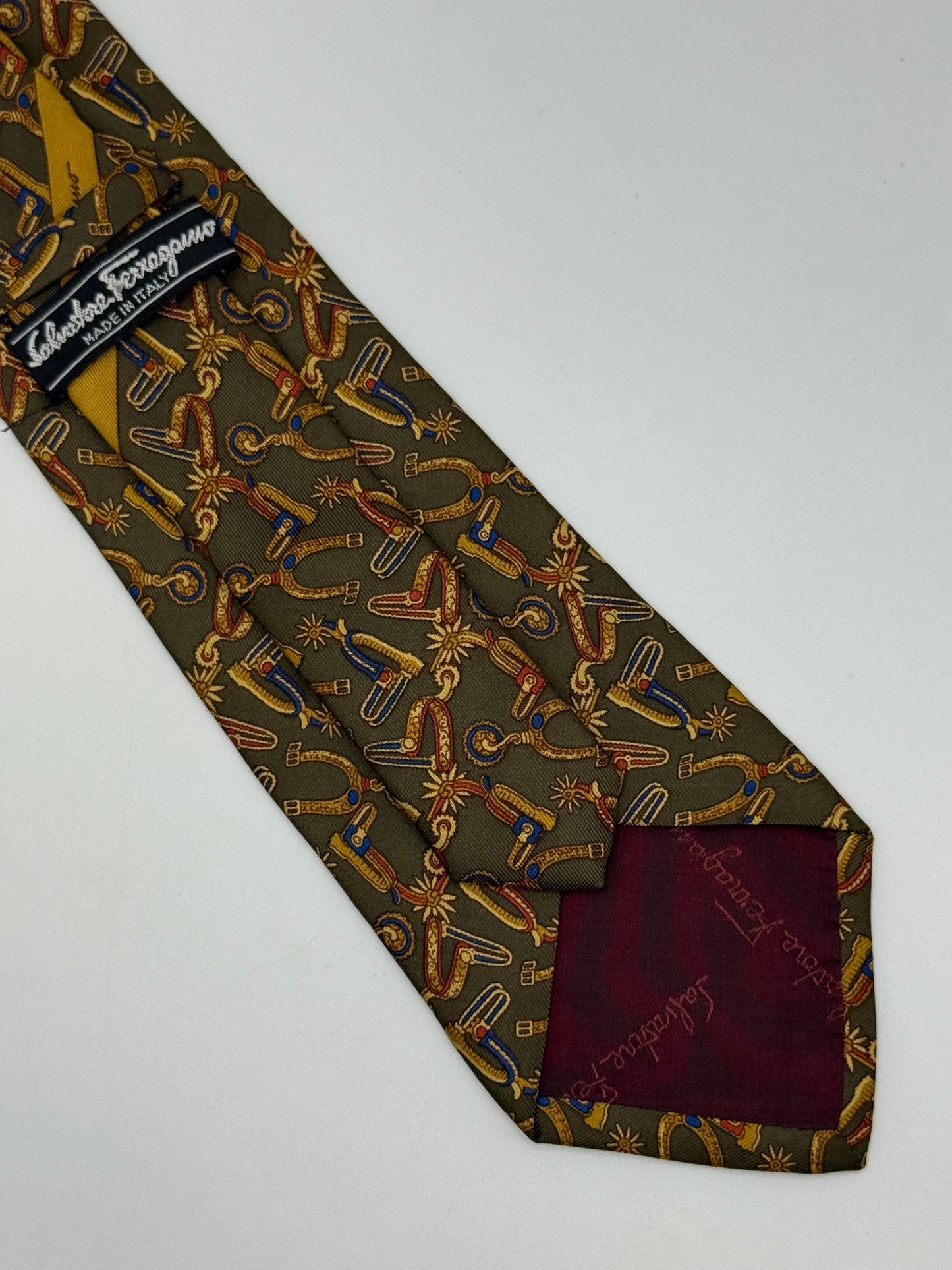 Dark green silk tie whit spurs pattern